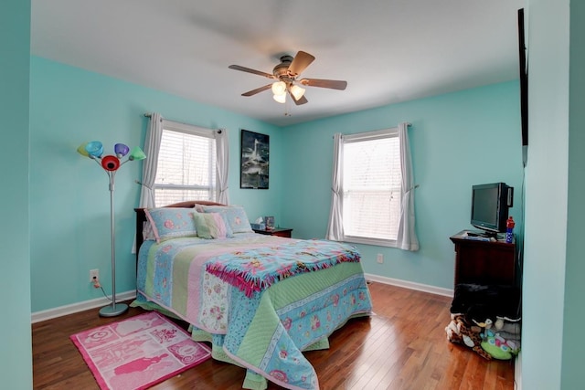 bedroom featuring hardwood / wood-style floors, multiple windows, and ceiling fan