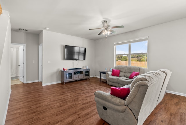 living room featuring ceiling fan and dark hardwood / wood-style flooring