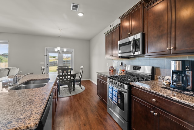 kitchen featuring sink, dark wood-type flooring, stainless steel appliances, and a wealth of natural light