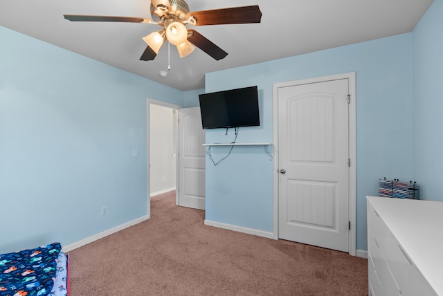 unfurnished bedroom featuring ceiling fan, light colored carpet, and a closet