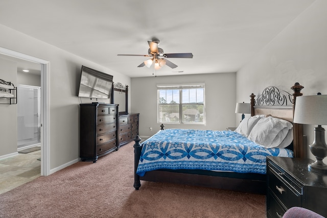 carpeted bedroom featuring ensuite bath and ceiling fan