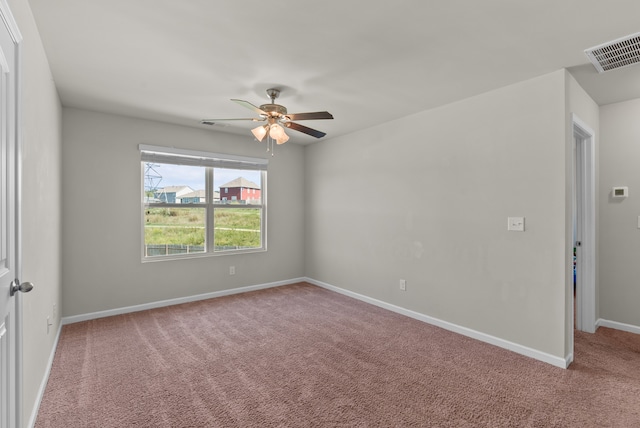 carpeted spare room with ceiling fan