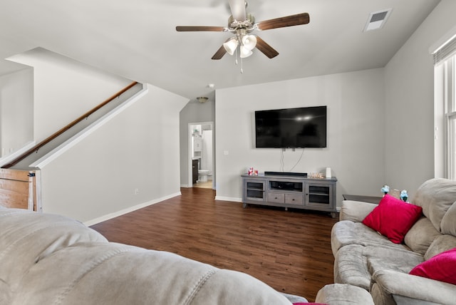 living room with lofted ceiling, ceiling fan, and dark wood-type flooring