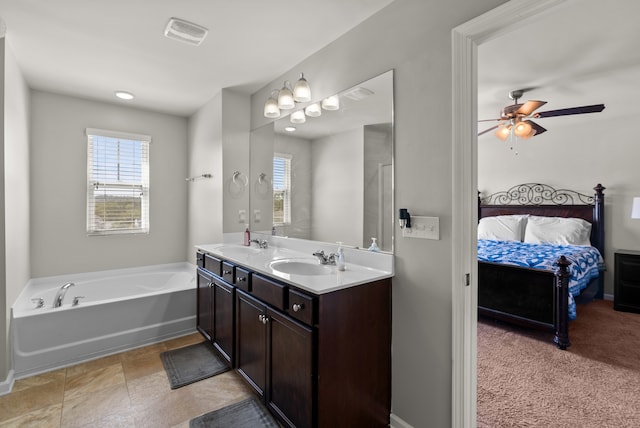 bathroom with ceiling fan, vanity, and a bathtub