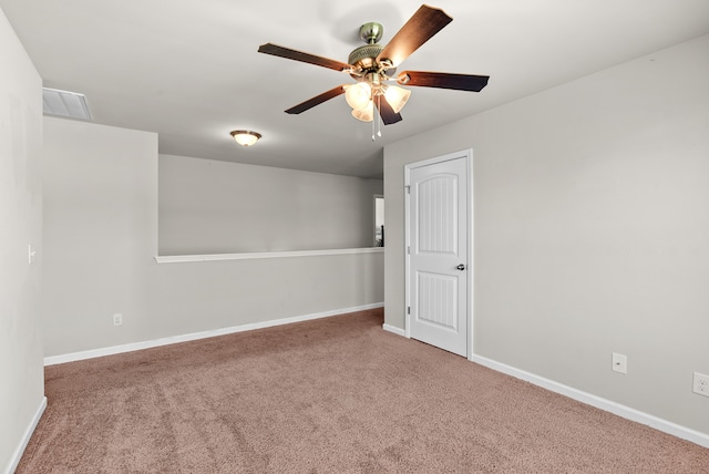 carpeted empty room featuring ceiling fan