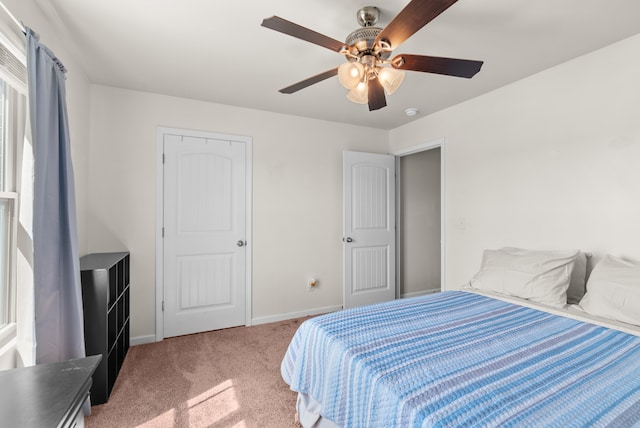 bedroom featuring ceiling fan and carpet