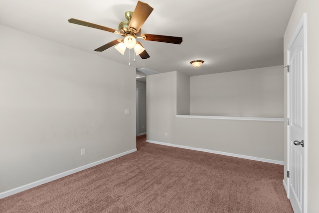 carpeted spare room featuring ceiling fan