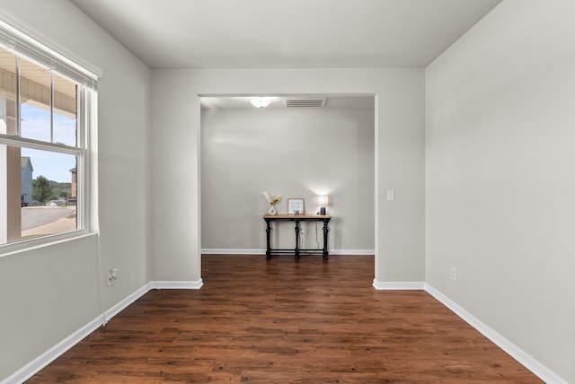 unfurnished room featuring dark wood-type flooring