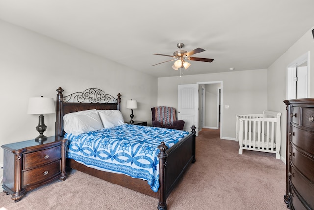 bedroom with ceiling fan and light colored carpet