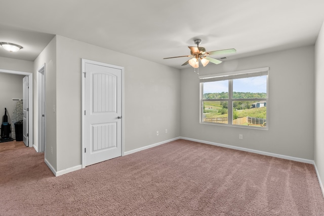 interior space with ceiling fan and carpet floors