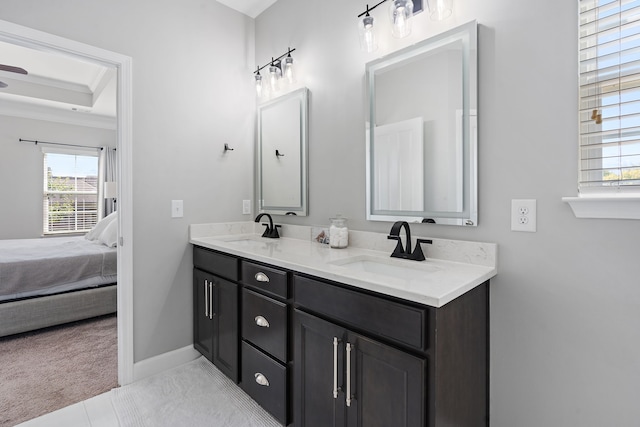 bathroom with vanity and a raised ceiling