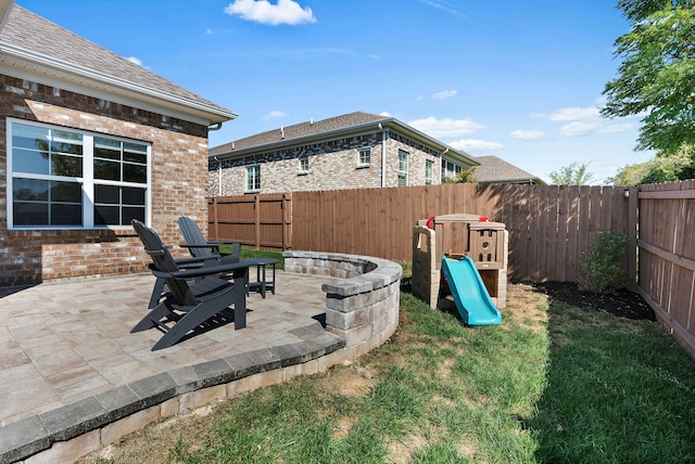 exterior space featuring a playground and a patio