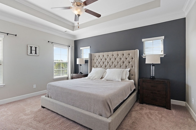 carpeted bedroom featuring ceiling fan, a raised ceiling, and crown molding