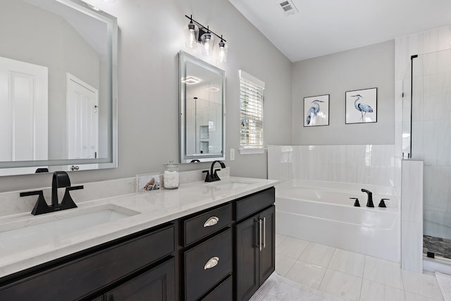 bathroom featuring vanity, shower with separate bathtub, and tile patterned floors