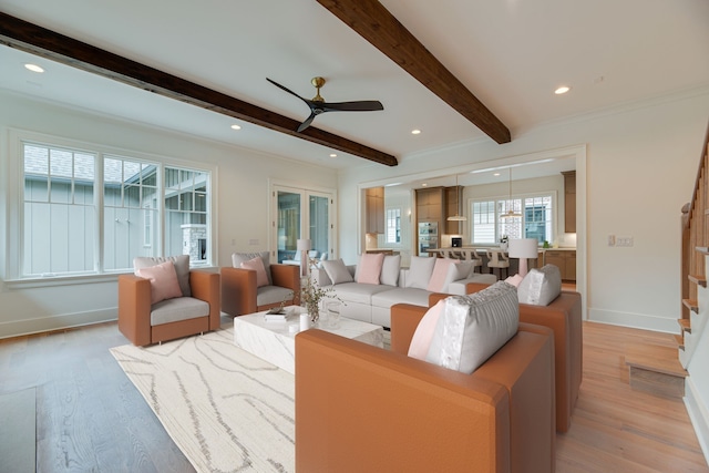 living room with beam ceiling, light hardwood / wood-style floors, and ceiling fan