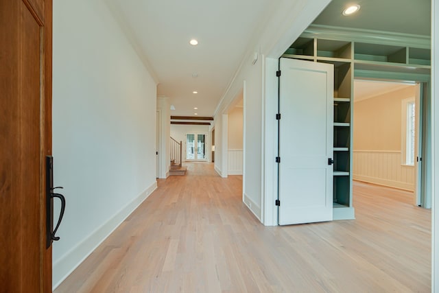 corridor featuring crown molding and light hardwood / wood-style floors