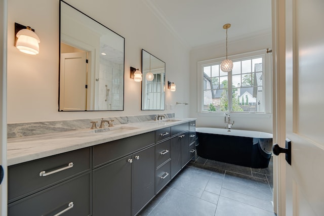 bathroom with vanity, tile patterned floors, ornamental molding, and a bathing tub