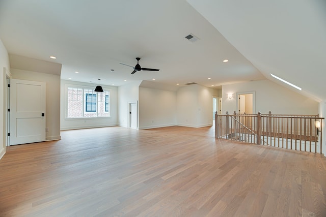 unfurnished living room featuring lofted ceiling, light hardwood / wood-style flooring, and ceiling fan