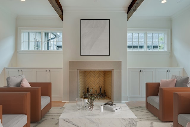 living room featuring light hardwood / wood-style floors, beamed ceiling, and ornamental molding