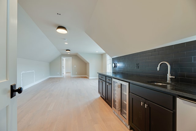 interior space with wine cooler, lofted ceiling, sink, and light hardwood / wood-style floors