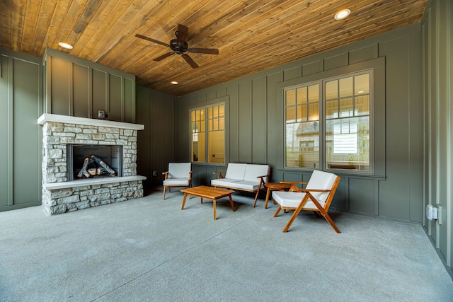 living area featuring light carpet, wood ceiling, and a fireplace