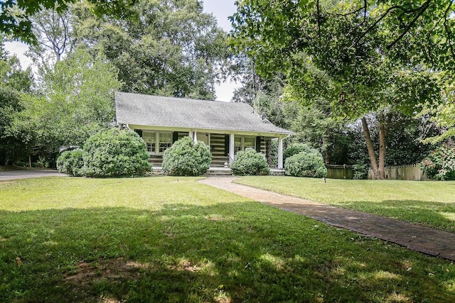 log cabin with a front lawn and covered porch