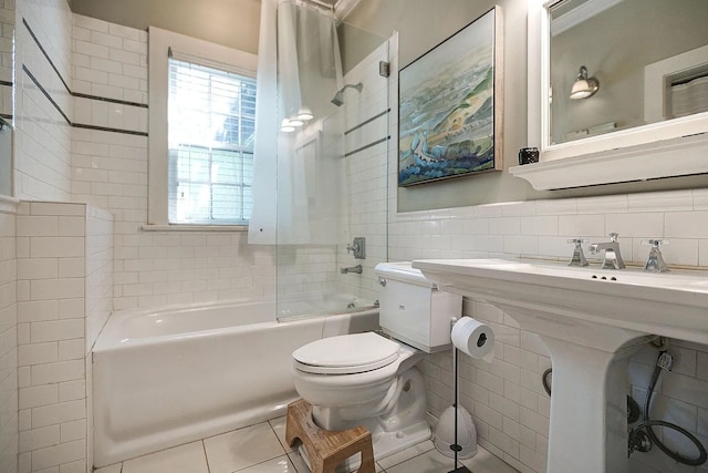 bathroom with tile walls, tile patterned flooring, toilet, and tasteful backsplash