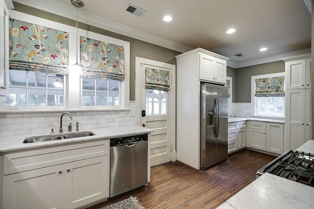 kitchen featuring white cabinetry, stainless steel appliances, decorative light fixtures, dark hardwood / wood-style floors, and sink