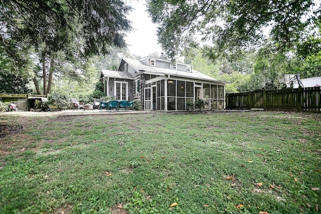 view of yard with a sunroom and a patio area