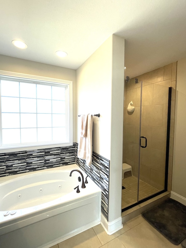 bathroom featuring tile patterned flooring and separate shower and tub