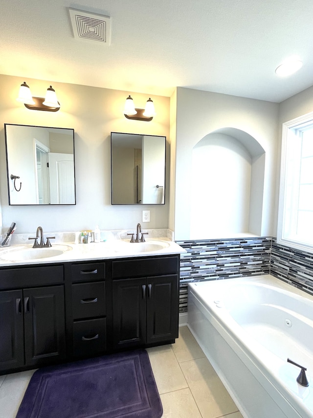 bathroom with vanity, a tub to relax in, and tile patterned flooring