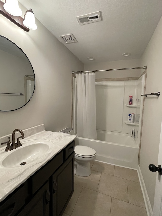 full bathroom with shower / tub combo, vanity, a textured ceiling, toilet, and tile patterned floors