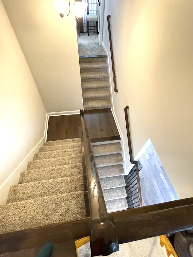 stairs featuring wood-type flooring