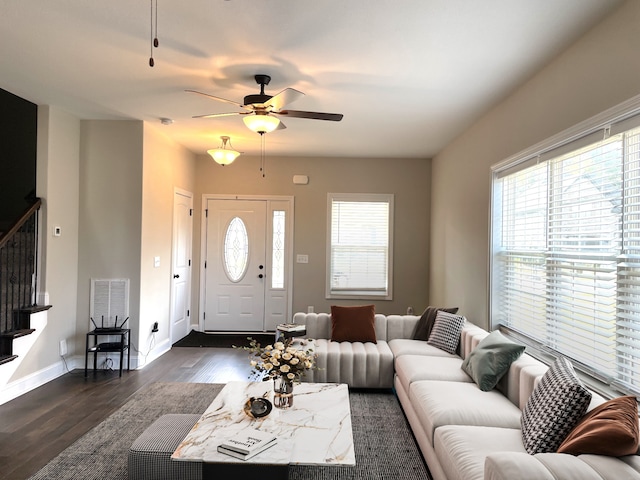 living room featuring ceiling fan and dark hardwood / wood-style floors