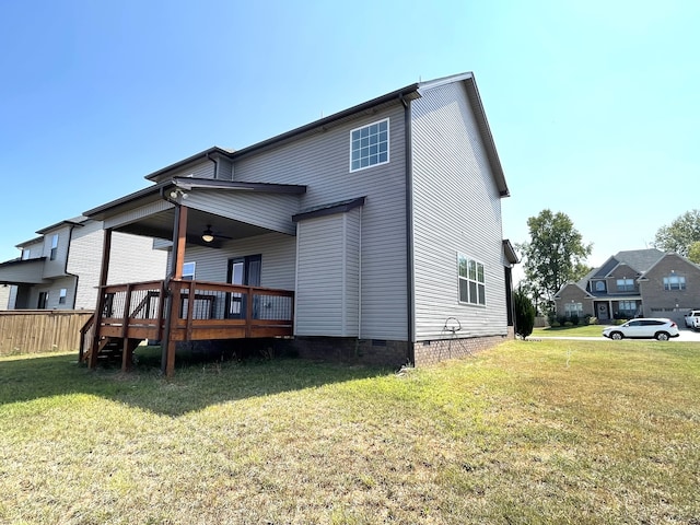 rear view of house with a deck and a yard