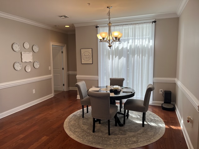 dining space with a notable chandelier, crown molding, and dark hardwood / wood-style flooring