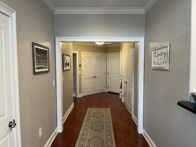 corridor with ornamental molding and dark hardwood / wood-style flooring