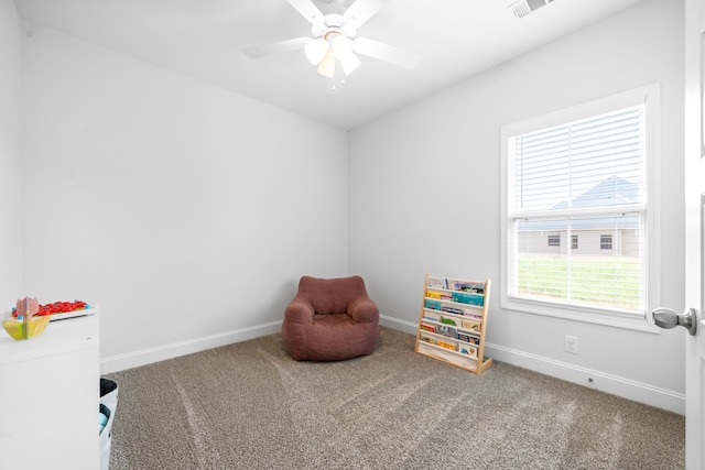 interior space with carpet floors and ceiling fan