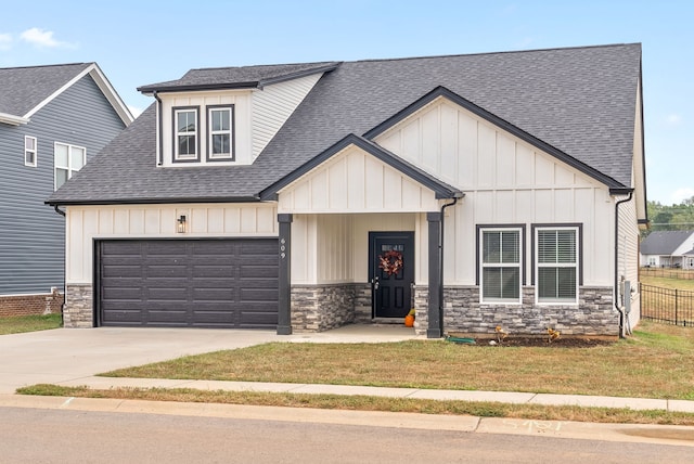 view of front of property featuring a garage and a front lawn