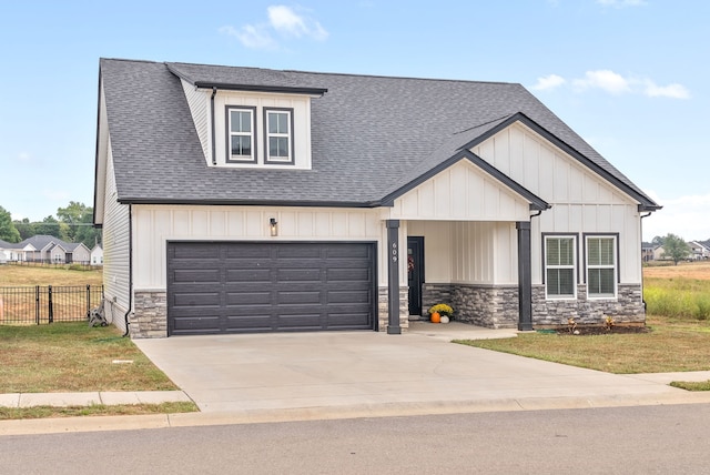 view of front of home featuring a garage and a front yard