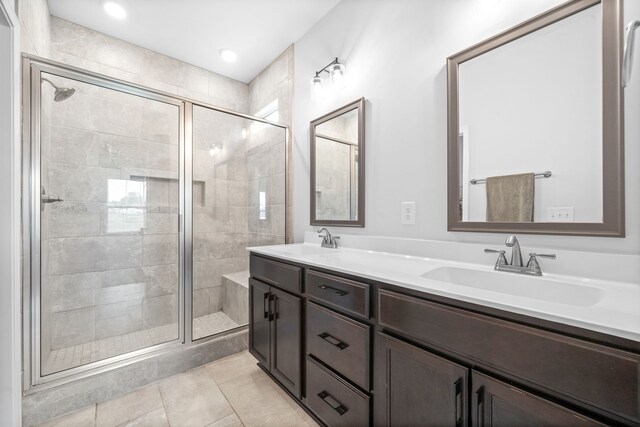 bathroom featuring walk in shower, vanity, and tile patterned floors