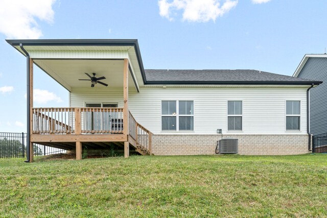 rear view of house featuring ceiling fan, a deck, a lawn, and central AC