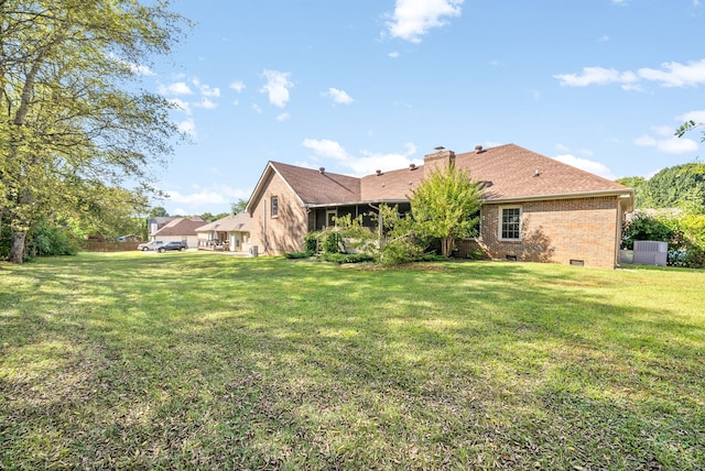 rear view of house featuring a lawn