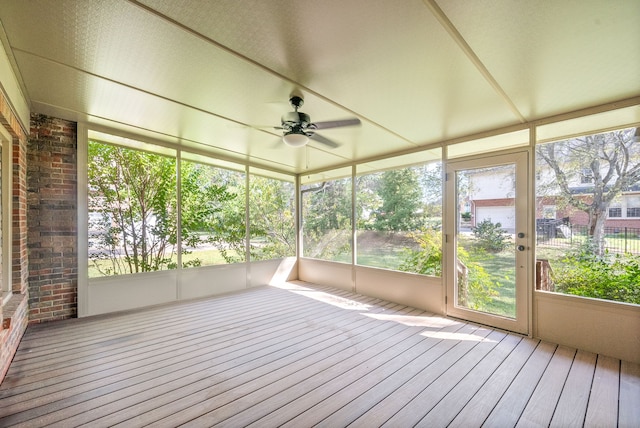 unfurnished sunroom with ceiling fan and a healthy amount of sunlight