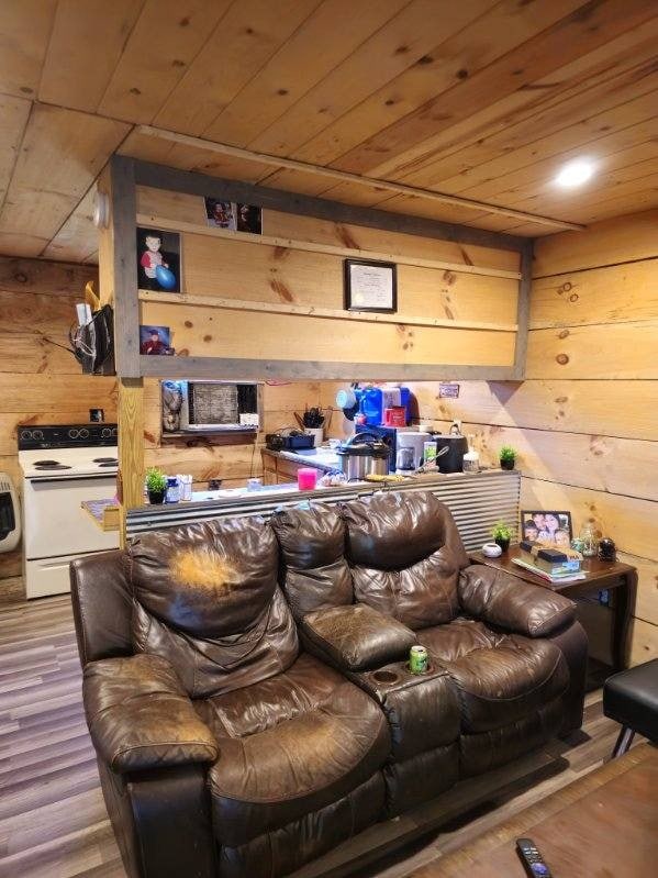 home theater featuring hardwood / wood-style flooring and wooden walls