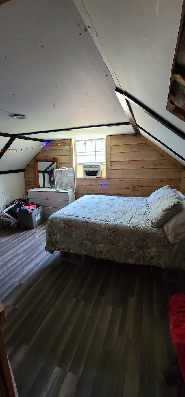 bedroom with hardwood / wood-style floors, vaulted ceiling, cooling unit, and wood walls