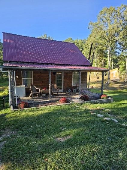 rear view of house with a patio area and a lawn