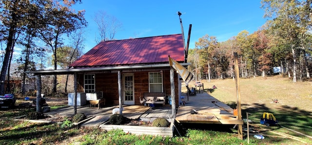 rear view of property featuring a deck