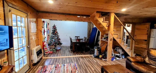 interior space with a healthy amount of sunlight, wood ceiling, and heating unit