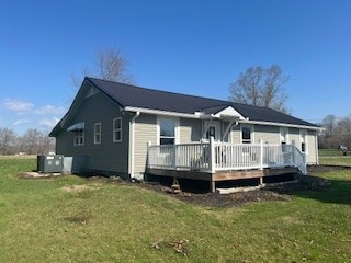 back of house with a lawn, cooling unit, and a deck